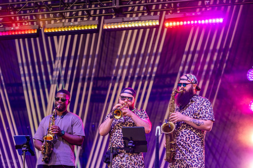 A group of musicians on stage at a festival