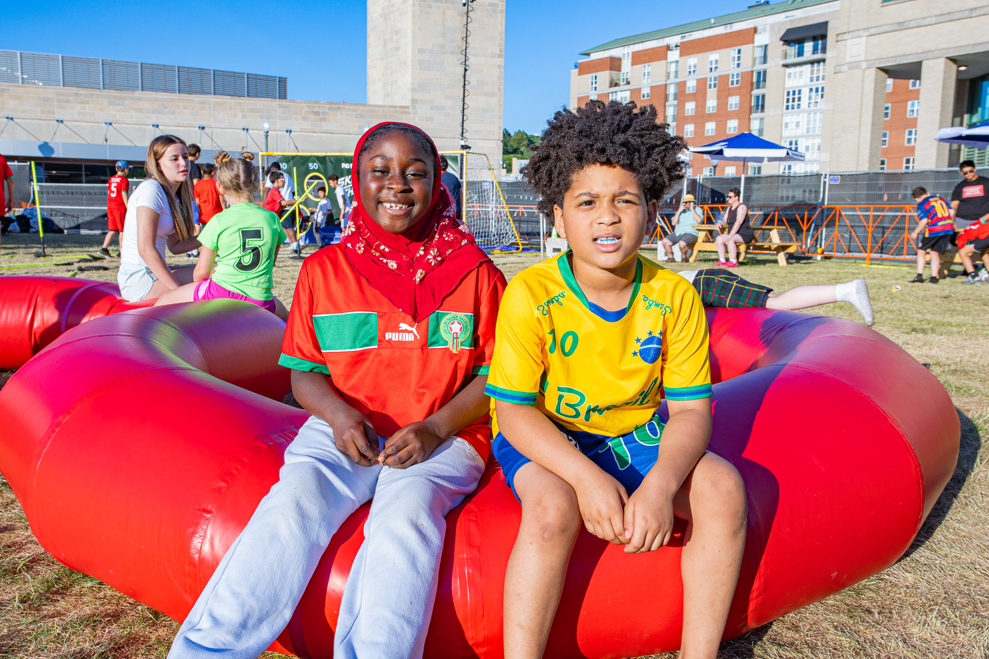 children sitting on inflatable tubes at the pvd fanzone